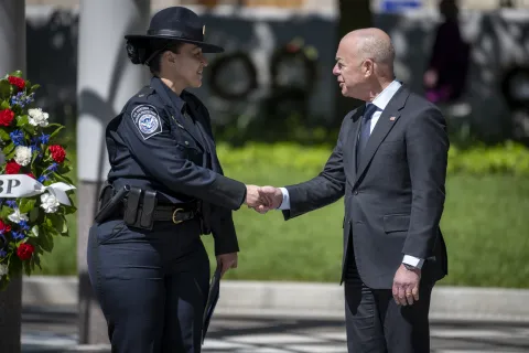 Homeland Security Secretary Alejandro Mayorkas greets a Customs and Border Protection Officer at the National Law Enforcement Officers Memorial as part of the 2022 National Police Week.