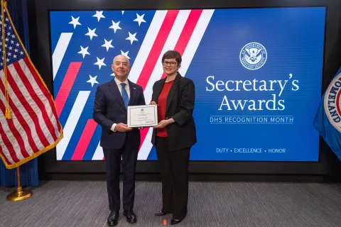 DHS Secretary Alejandro Mayorkas with Innovation Award recipient, Lindsey Cerkovnik.