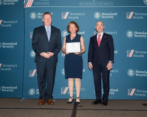 Left to right: U.S. Secret Service Director James Murray, Innovation Award recipient Laurie A. Fulk, and DHS Secretary Alejandro Mayorkas.