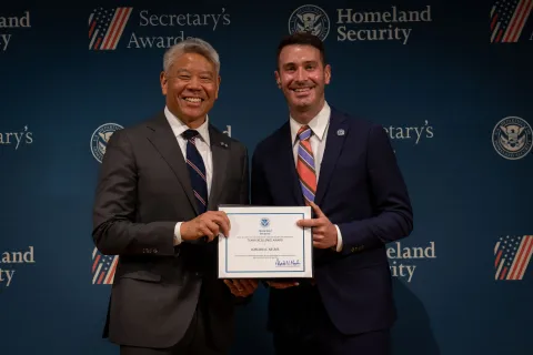 DHS Deputy Secretary John Tien with Team Excellence Award recipient, Jordan A. Nelms.