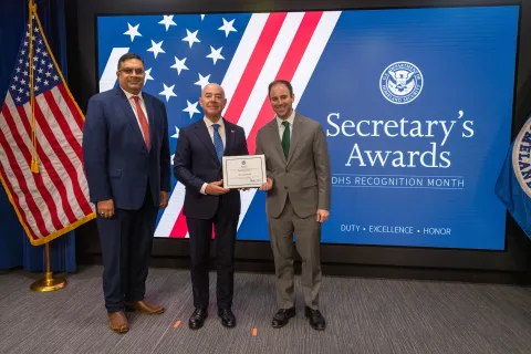 Left to Right: CISA Deputy Director Nitin Natarajan, DHS Secretary Alejandro Mayorkas, and  Innovation Award recipient, Erik Snyderman.