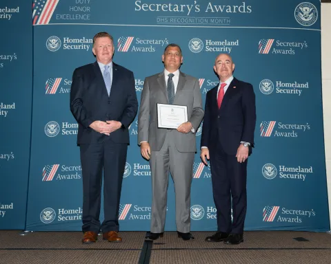 Caption: Left to right: U.S. Secret Service Director James Murray, Innovation Award recipient Zachary N. Ainsworth, and DHS Secretary Alejandro Mayorkas., D.C. (May 6, 2022) Homeland Security Secretary Alejandro Mayorkas participates in a Secretary’s Awards Ceremony honoring U.S. Secret Service Agents in recognition of their hard work and dedication over the past year. (DHS Photo by Benjamin Applebaum)