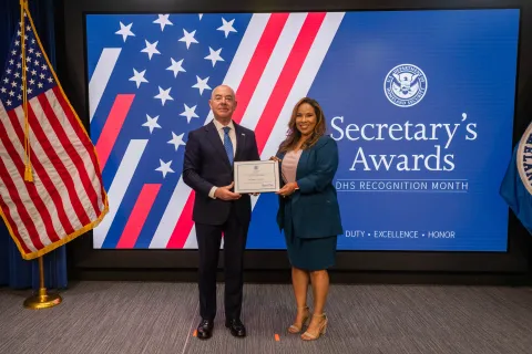 DHS Secretary Alejandro Mayorkas with Team Excellence Award recipient, Melanie A. Murguia.