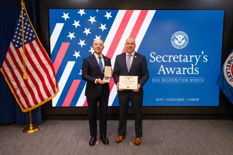 DHS Secretary Alejandro Mayorkas and Secretary's Gold Medal recipient Herbert Wolfe.