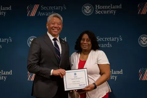DHS Deputy Secretary John Tien with Team Excellence Award recipient, Muriel A. Glover.
