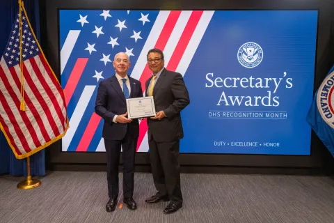DHS Secretary Alejandro Mayorkas with Team Excellence Award recipient, Louis P. Goler.
