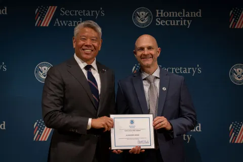 DHS Deputy Secretary John Tien with Team Excellence Award recipient, Alexander Wood.