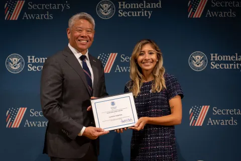 DHS Deputy Secretary John Tien with Team Excellence Award recipient, Claudia Cisneros.