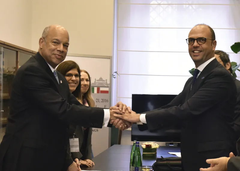 Secretary Johnson shakes hands with Italian Interior Minister Alfano.