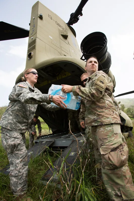 Coamo, Puerto Rico -- Members of the Armor Unit Combat Aviation Division from Ft. Bliss, Texas deliver emergency water supplies to an isolated village.