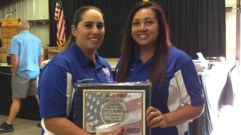 Elisa Garcia-Lozano and Elaine Lawless holding up their award from the Classified Team Divisions. (Photo courtesy of ICE)