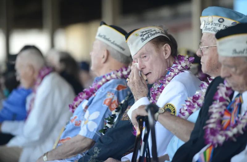 A surviving U.S. servicemember reflects during a ceremony for the 75th Commemoration of the attack on Pearl Harbor