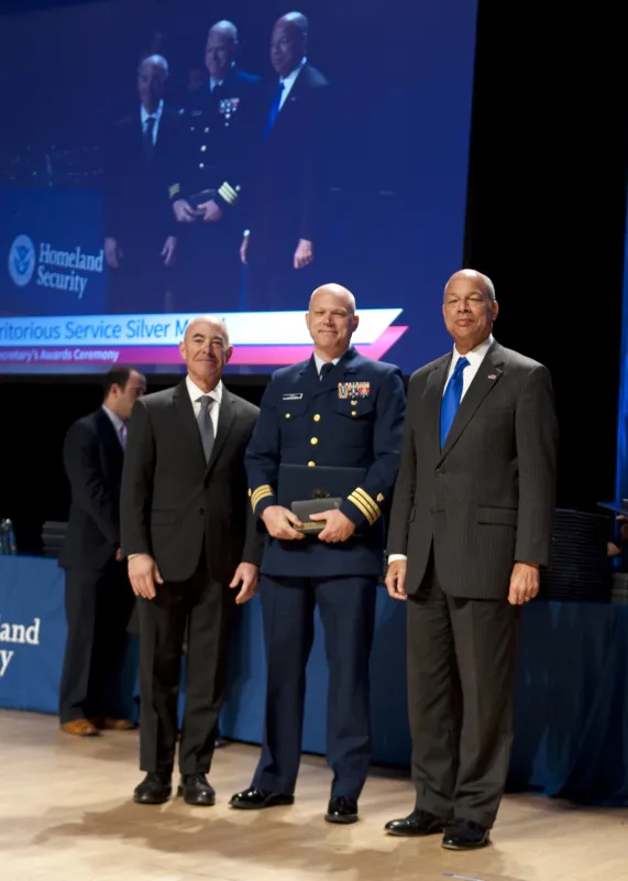 Secretary of Homeland Security Jeh Johnson and Deputy Secretary of Homeland Security Alejandro Mayorkas presented the Secretary's Meritorious Service Medal to Coast Guard Cmdr. James Forgy