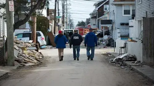 FEMA workers walking through disaster site