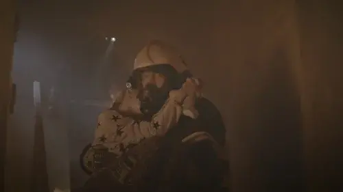 Firefighter rescuing child from burning house