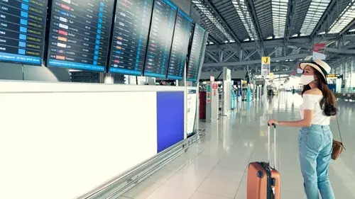 Woman looking at flight departure monitors