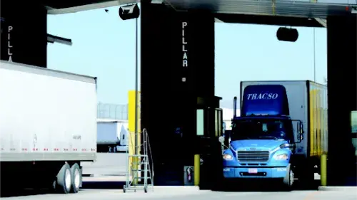 Shipping trucks driving the a truck weigh station