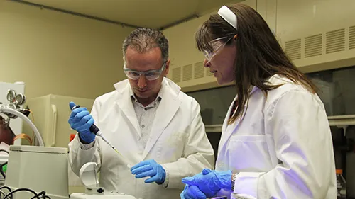lab technicians in lab using testing equipment