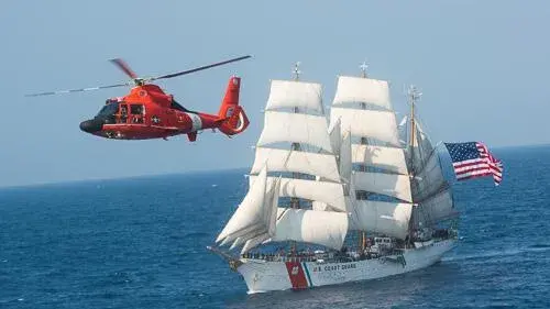 U.S. Coast Guard helicopter and sail boat