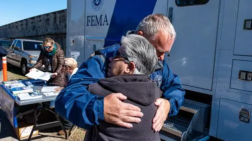 Disaster survivor hugs FEMA staff