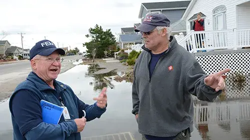 FEMA employee talking to person directly effected by recent hurricane in 2022