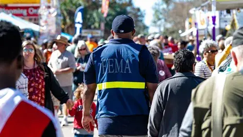FEMA employee walking through crowd