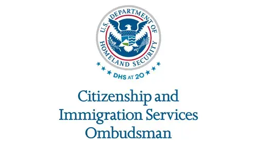 Vertical CISOMB wordmark/lockup in blue with "DHS at 20" below the DHS seal