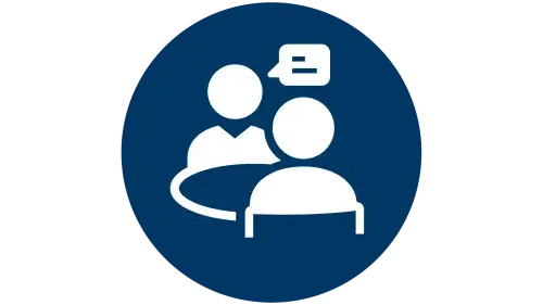 Icon of person interviewing another person with table in the middle