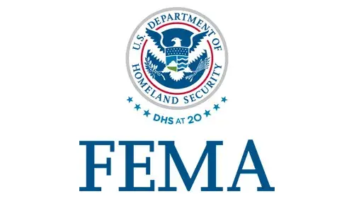 Vertical FEMA wordmark/lockup in blue with "DHS at 20" below the DHS seal