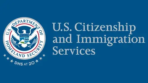 Horizontal USCIS wordmark/lockup in gray with "DHS at 20" below the DHS seal