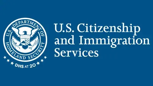 Horizontal USCIS wordmark/lockup in monochrome white with "DHS at 20" below the DHS seal