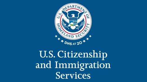 Vertical USCIS wordmark/lockup in white with "DHS at 20" below the DHS seal