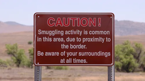 Cation sign in explaining smuggling activity is common in the area and to be aware of your surroundings..