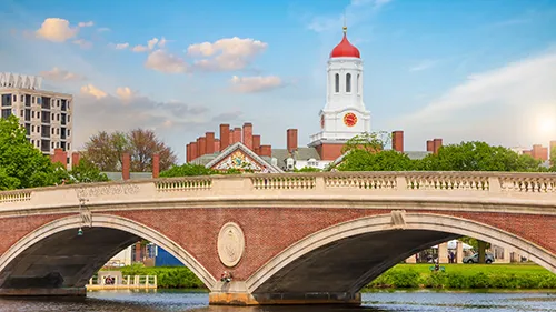 John W. Weeks vintage Bridge with clock tower over Charles River in Harvard University campus Boston.