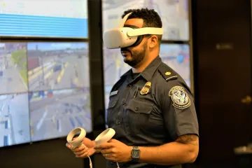 An officer wearing a virtual reality goggle.