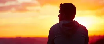 Man overlooking the sunset