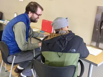 A DHS employee conducts a usability test in the field with a participant from the public