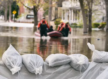 sands bag and first responders in boat during a flood