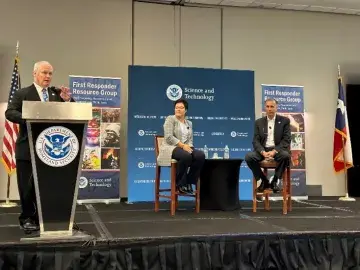 Under Secretary Dimitri Kusnezov and U.S. Fire Administrator Dr. Lori Moore-Merrell watch on stage as S&T First Responder Portfolio Director speaks at the 2023 FRRG Meeting.