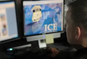 ICE Agent works on Computer during Operation iGuardian