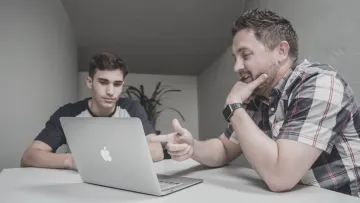 Father and son looking at a laptop