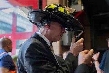 Under Secretary Dimitri Kusnezov test-drives C-THRU technology with the firefighter helmet on his head.