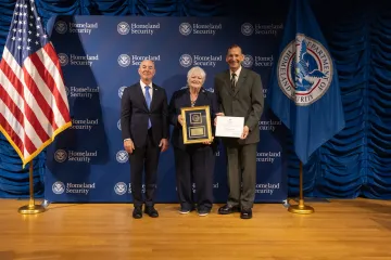 DHS Secretary Alejandro Mayorkas (left) with Leadership Excellence Award recipient, Edith Moore McGee (center), and Deputy Under Secretary for Management, Randolph Alles (right).