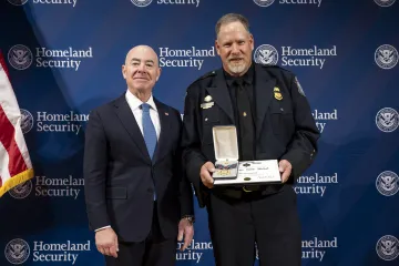 DHS Secretary Alejandro Mayorkas with Secretary's Gold Medal recipient, John Nyegaard.