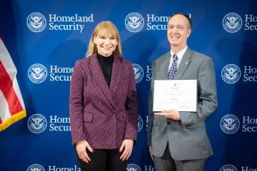 Acting DHS Deputy Secretary Kristie Canegallo with Innovation Award recipient, John Rein.