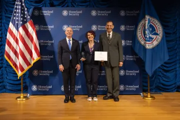 DHS Secretary Alejandro Mayorkas (left) with Innovation Award recipient, Dawn Barton (center), and Deputy Under Secretary for Management, Randolph Alles (right).