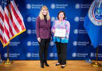 Acting DHS Deputy Secretary Kristie Canegallo and Secretary's Gold Medal recipient, Erin Buechel Wieczorek.