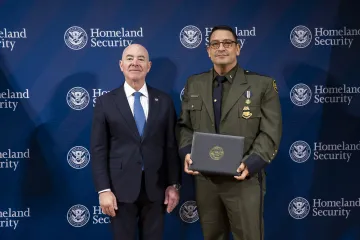 DHS Secretary Alejandro Mayorkas with Innovation Award recipient, Mark Garrison.