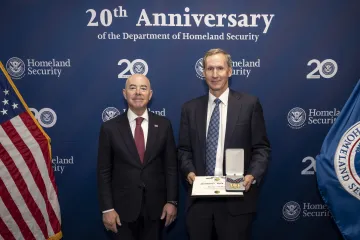 DHS Secretary Alejandro Mayorkas with Secretary's Gold Medal recipient Matthew McKeon.