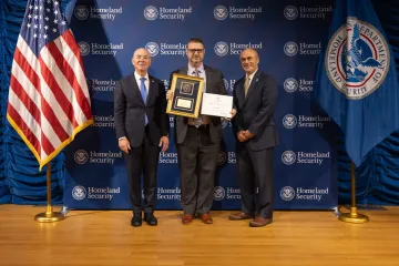 DHS Secretary Alejandro Mayorkas (left) with Leadership Excellence Award recipient, Josh Shuey (center), and DHS General Counsel Johnathan Meyer (right).
